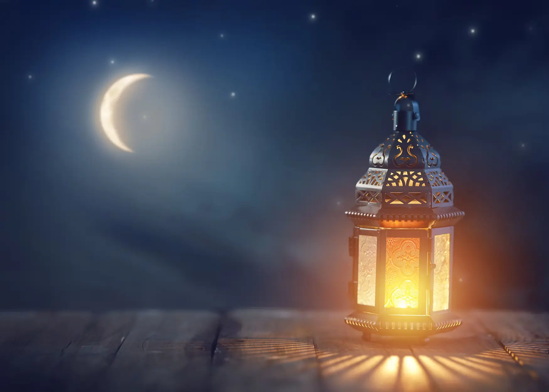 stardust therapy decorative image of a lantern on a table and the moon and stars in the background